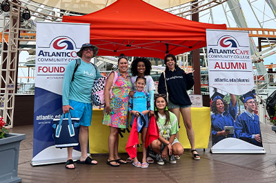 family smiling on the wildwood boardwalk