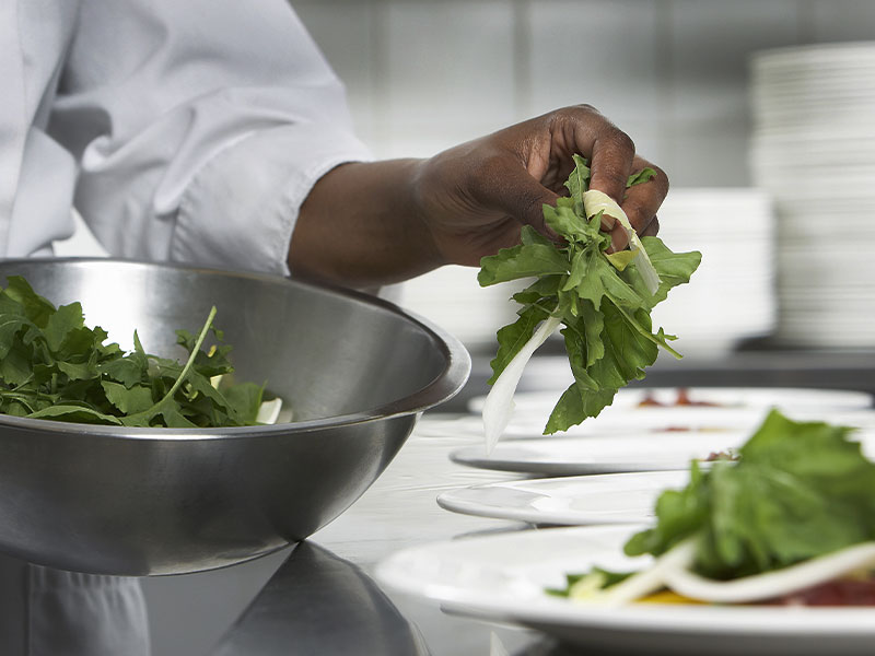culinary students with salad in a bowl