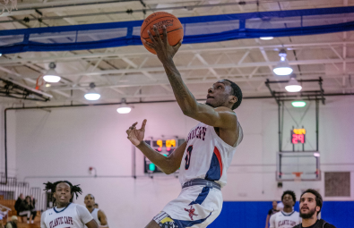 student athlete making a basket in basketball