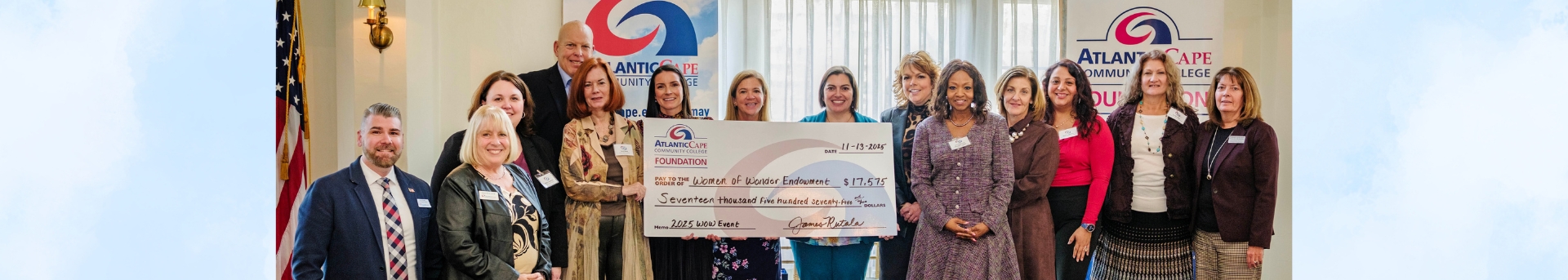 atlantic cape women of wonder foundation group posing with a check.