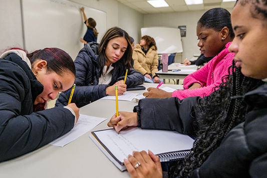 Atlantic Cape students work together on a classroom activity.