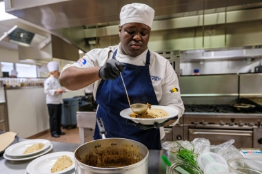 ACA culinary student preparing a dish