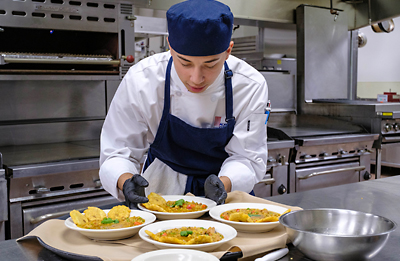 Culinary student in kitchen.