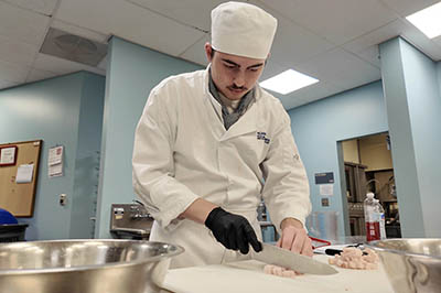 Cape May culinary student preparing food.