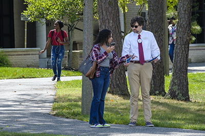 Instructor on tour with student on Mays Landing campus.