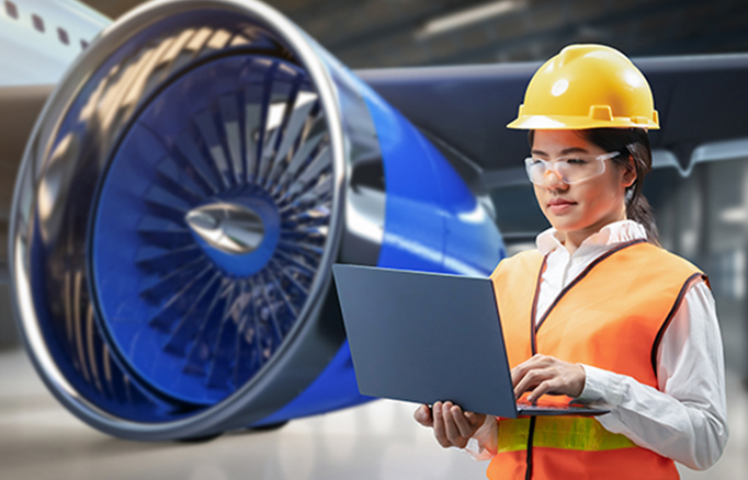 Student standing in front of an airplane engine on a runway.