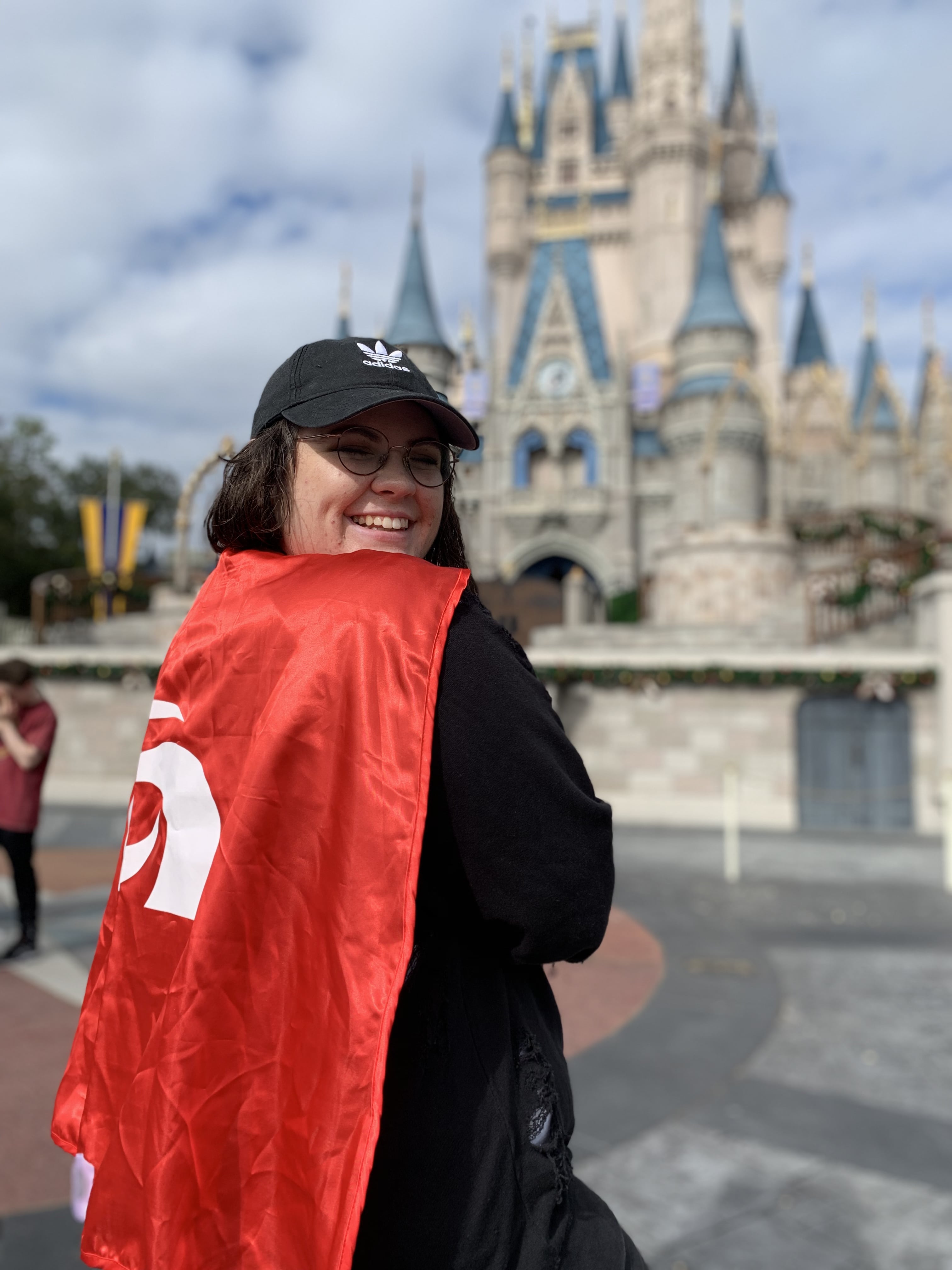 meghan clark wearing a cape at walt disney world