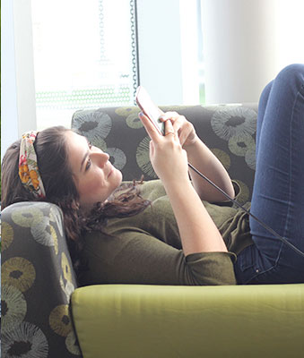 student lounging checking her phone