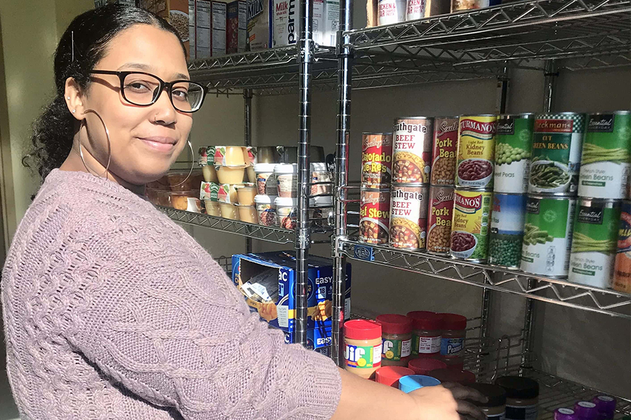 Person stocking the food pantry shelves