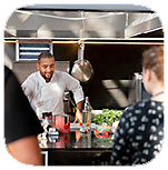 People learning cooking in a kitchen.