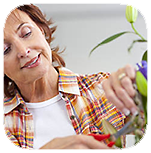 A lady taking care of a plant.