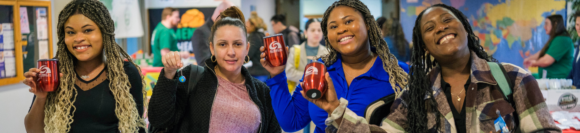 students smiling holding cups