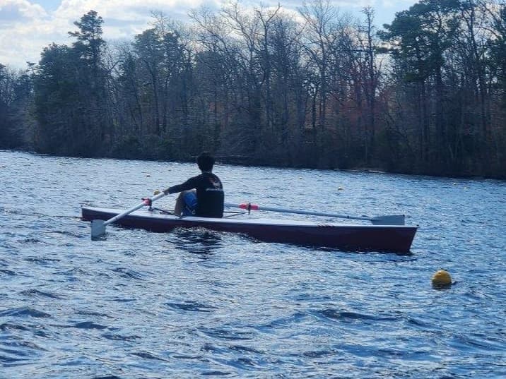 Atlantic rower on lake near woods