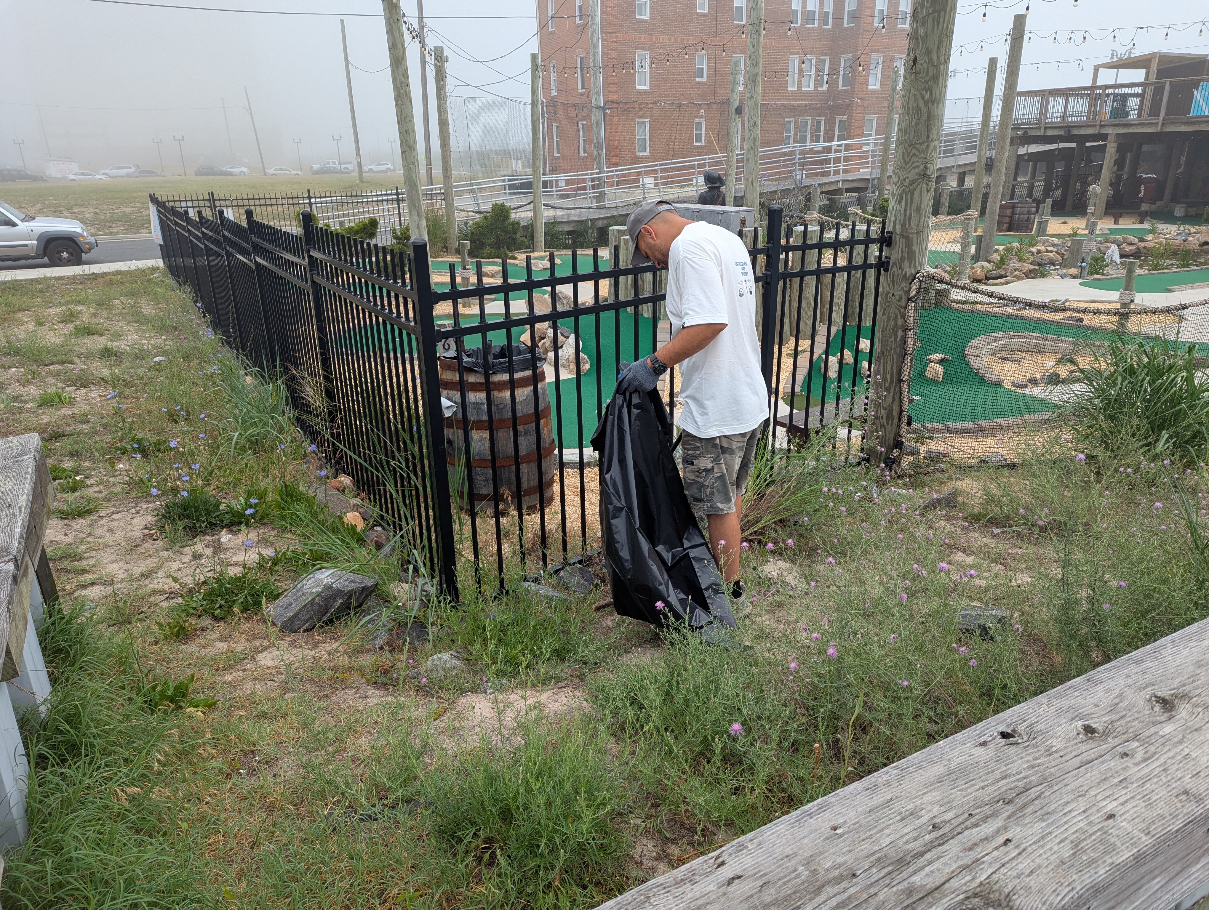 Inlet CDC Project Lead Mike Intrieri picks up debris near Altman Park
