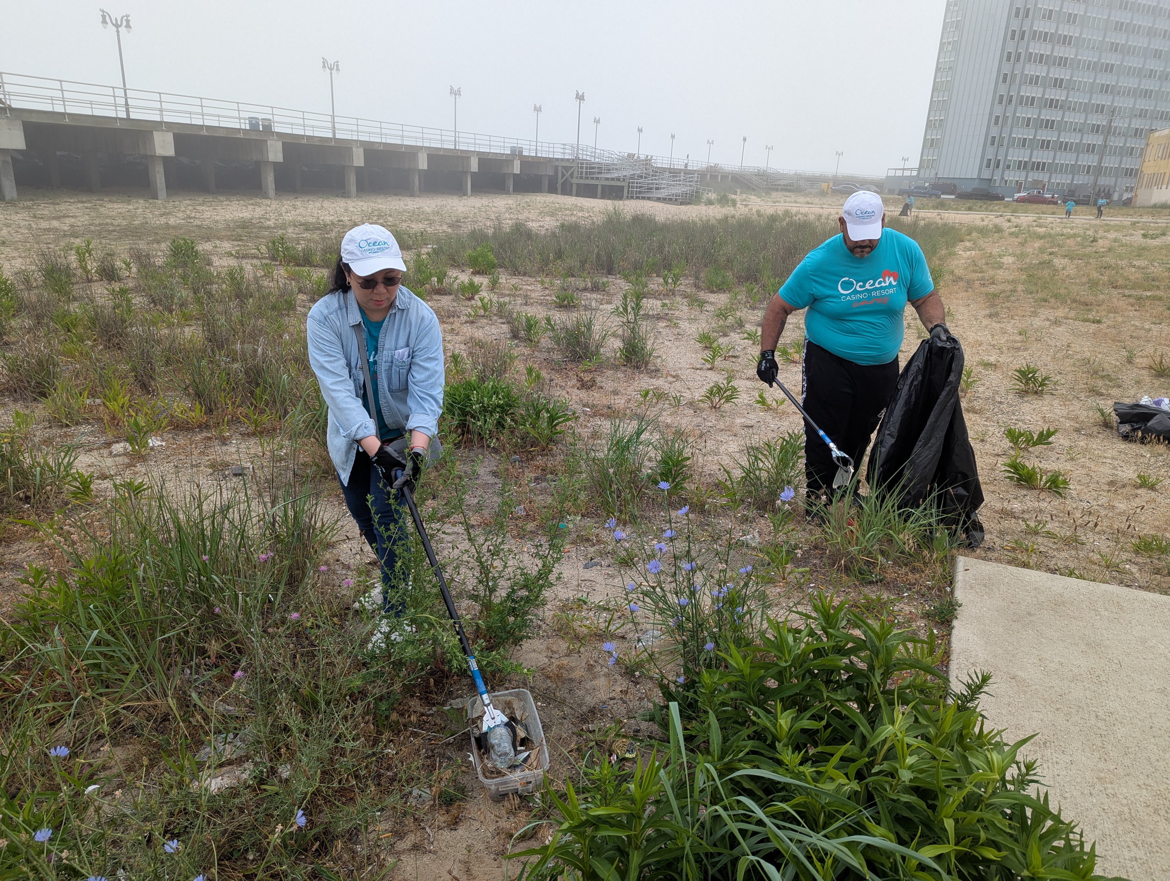 Carmelo Maysont and Karen Hober pick up debris