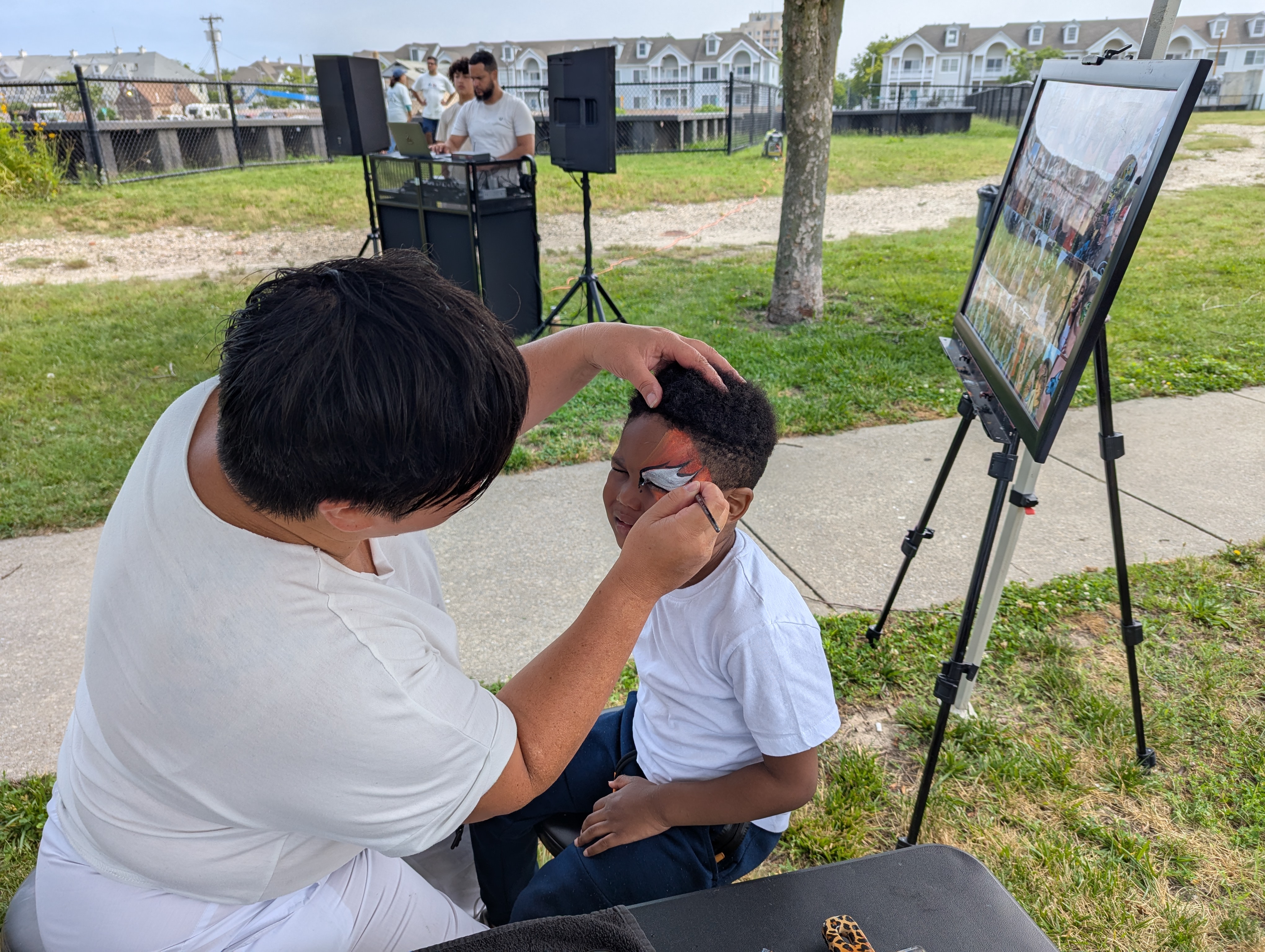 child gets his face painter during Summer Kick-off party