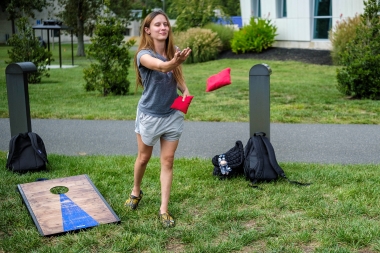 Playing a game of cornhole during Welcome Back event