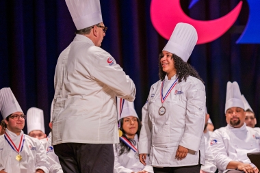 Danna Jimenez receives medal from Chef Joe Sheridan
