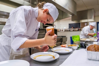 Payton Sinou prepares her plate