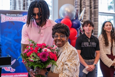 Dr. Gaba receives flowers and thanks from student–athlete Olyn Knox