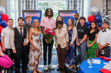 Dr. Gaba is accompanied by Buccaneer student–athletes
