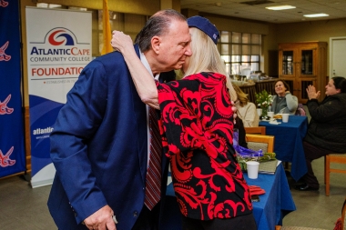 Nicholas Asselta hugs wife Nancy Small Asselta