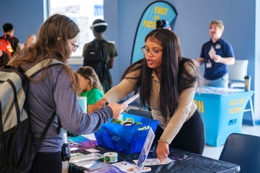 student speaks with an Atlantic Cape employee at IMALIVE mental health fari