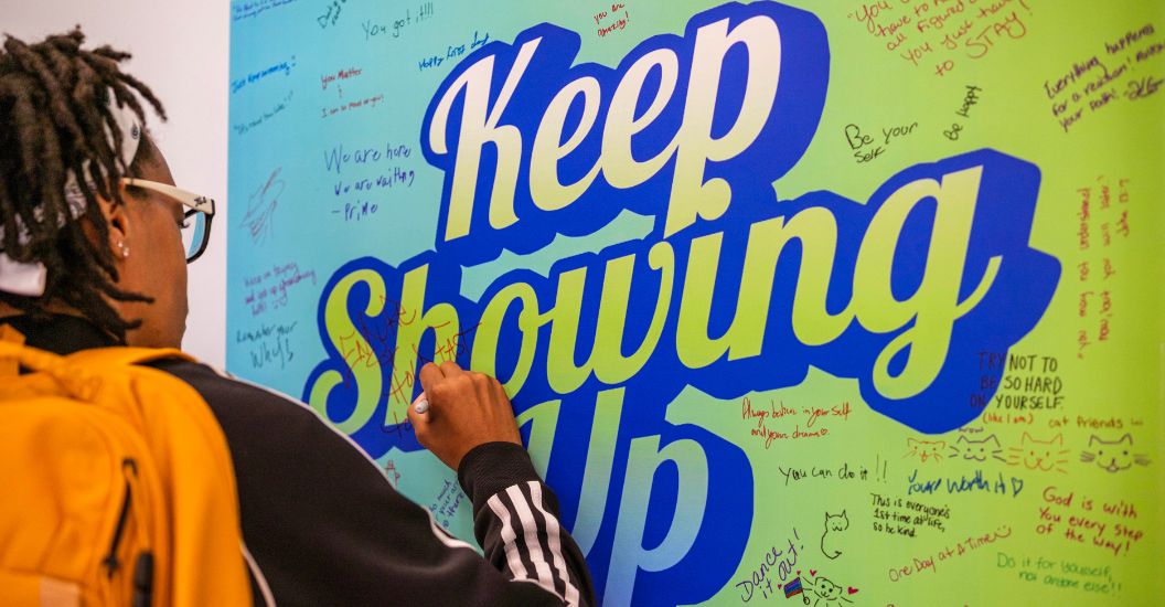 Student writes hopeful message during IMALIVE mental health fair