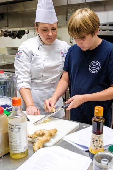Kids College student learns in the culinary kitchen