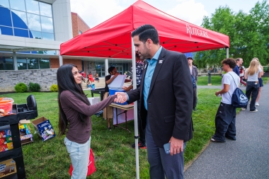 Atlantic Cape President Dr. Jason Abreu greets a student