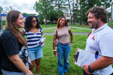 Women's soccer coach Wesley Raywood speaks to new students