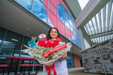 Practical Nursing program graduate celebrates with a unique bouquet of flowers