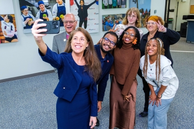 Secretary Chaly poses for a photo with students