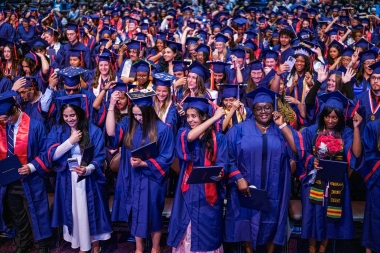Newly-minted graduates move their tassles