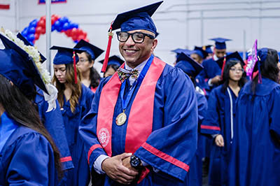 Graduate on the steps of Atlantic Cape