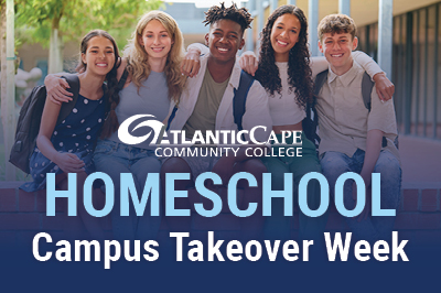 Group of students in front of the student center on the Mays Landing campus.
