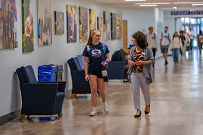 advisor talking to student in hallway