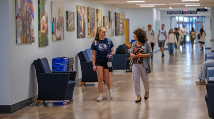 advisor talking to student in hallway