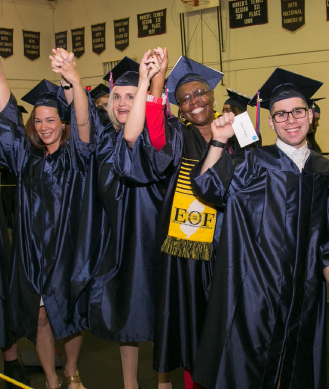 students posing in their cap and gowns
