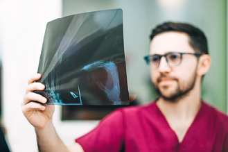 a nurse examines an x ray sheet
