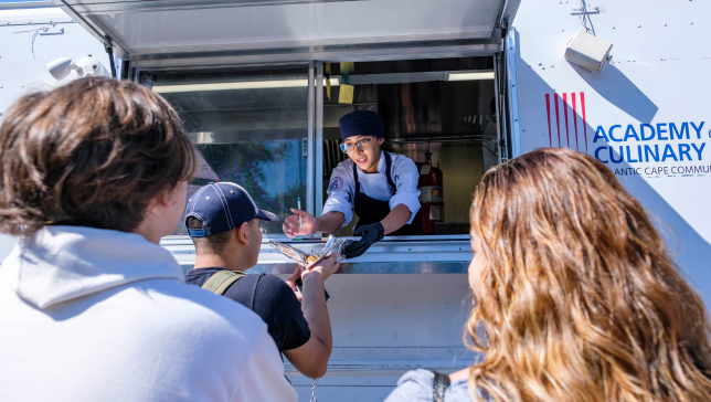 student serving food from food truck
