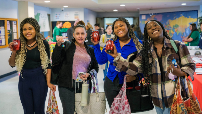 students smiling at an event