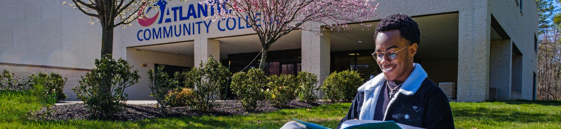 student reading in front of J Building