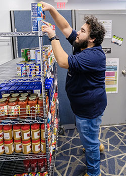 food pantry employee stocking shelves