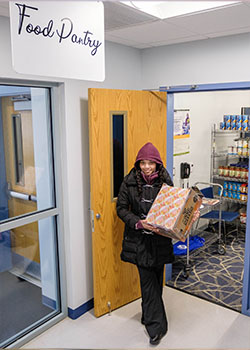 student holding food pantry items