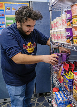 food pantry employee rearranging shelves