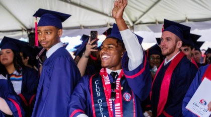 student smiling at graduation