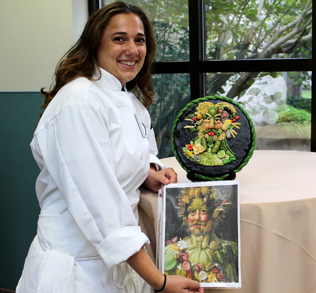 girl holding print of painting 