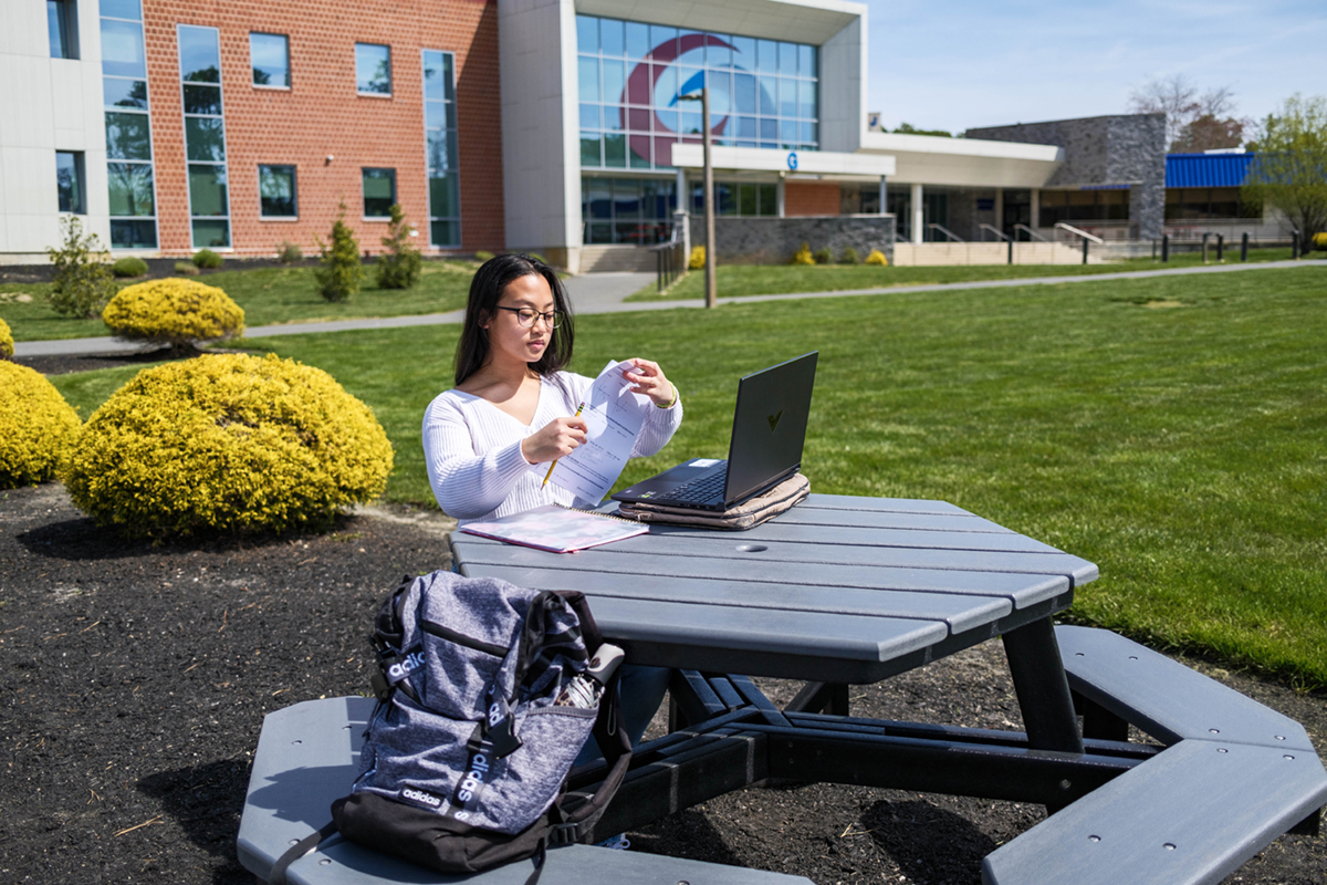 Atlantic Cape student in the quad studying