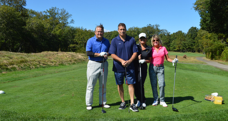 golfers standing together on the green